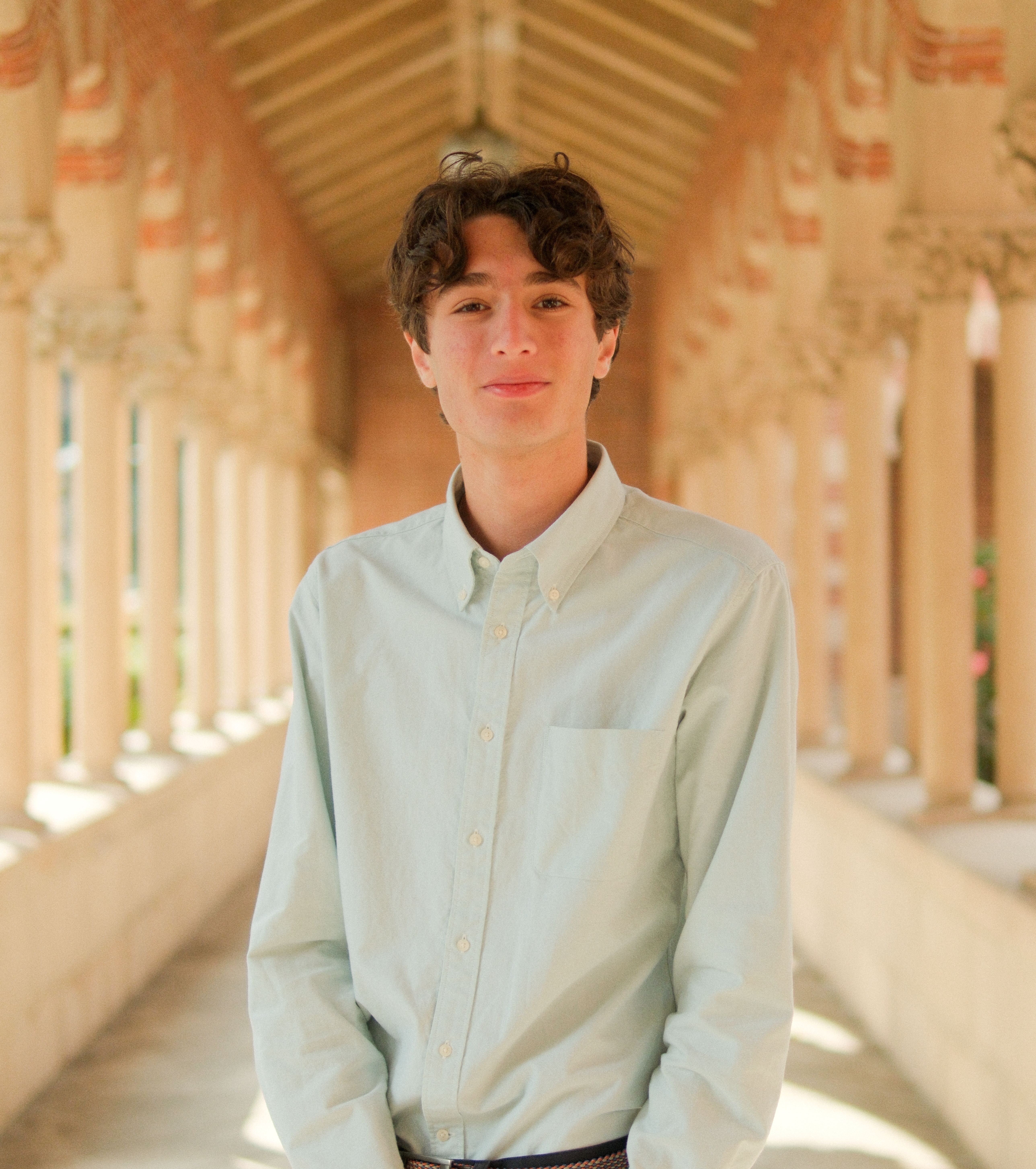 Miles Sanger in a sunlit arched walkway